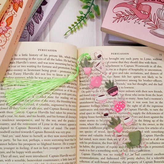 Botanical tea and plants bookmark for readers on an open book page.