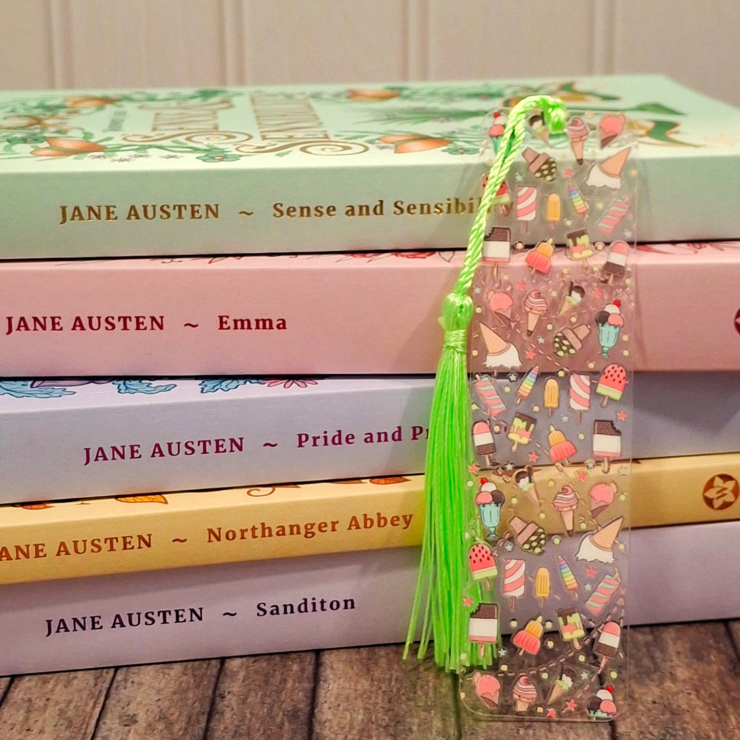 A stack of books and a sweet ice cream themed bookmark for book lovers.