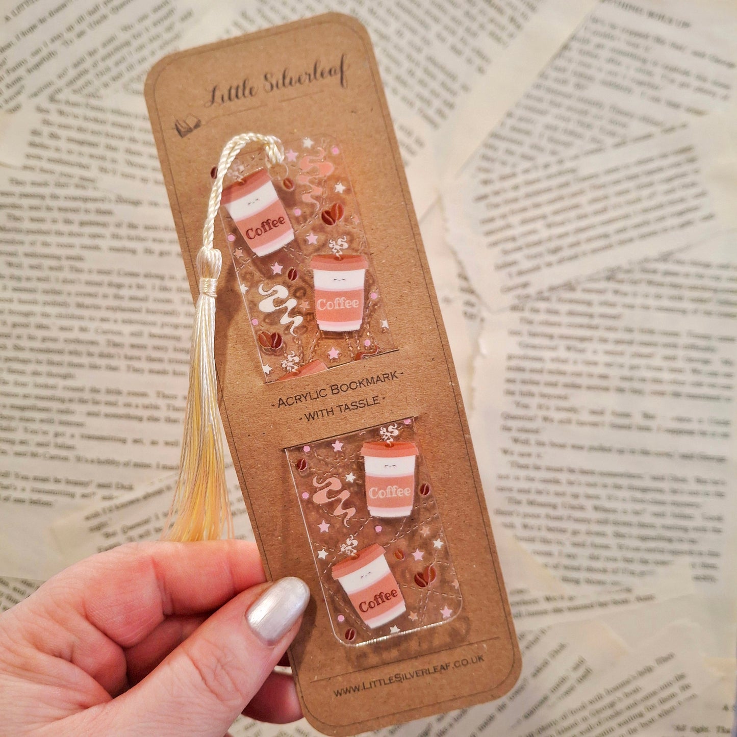 Coffee themed bookmark for coffee lovers and readers, packaged on a brown kraft backing card, held over a book page background.