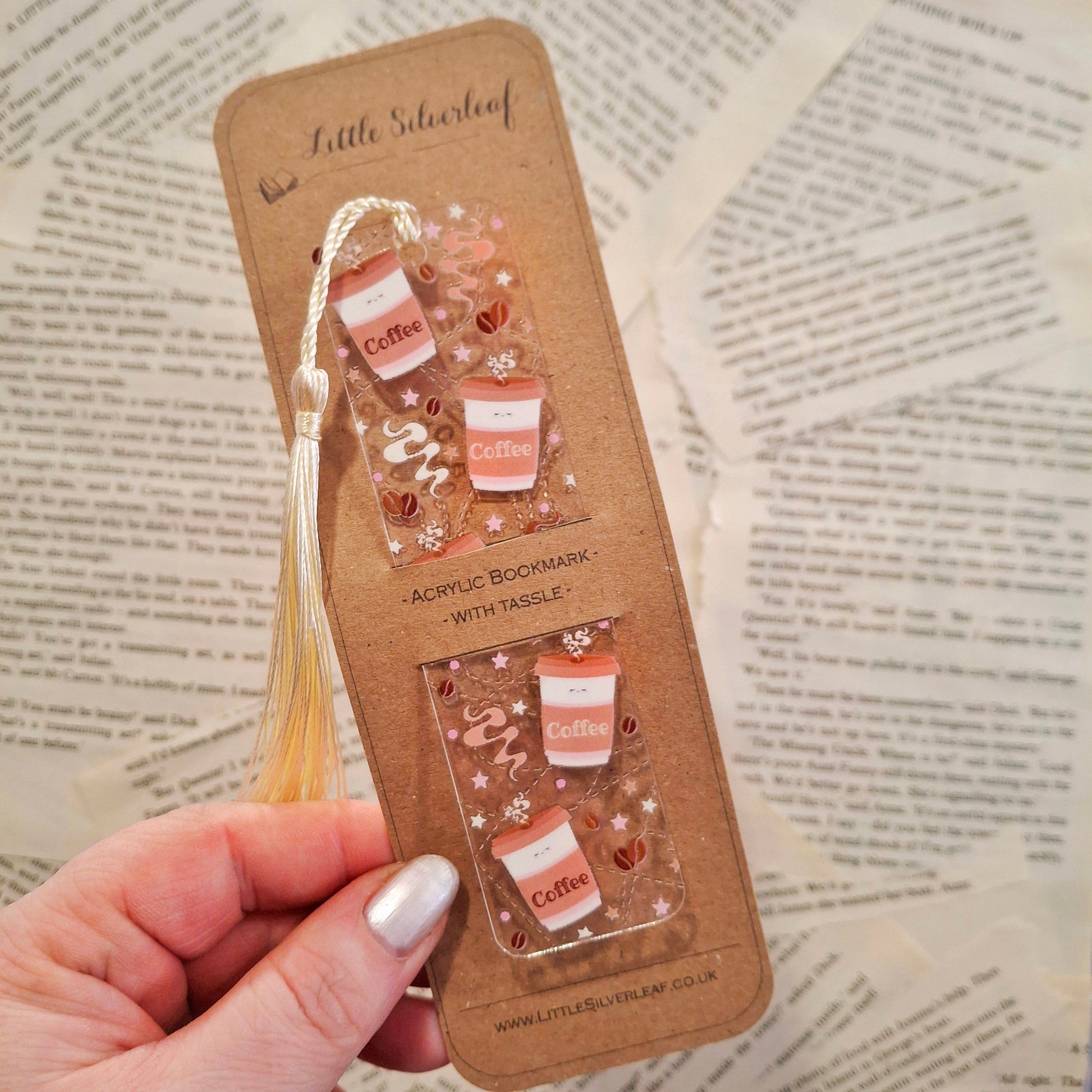Coffee themed bookmark for coffee lovers and readers, packaged on a brown kraft backing card, held over a book page background.