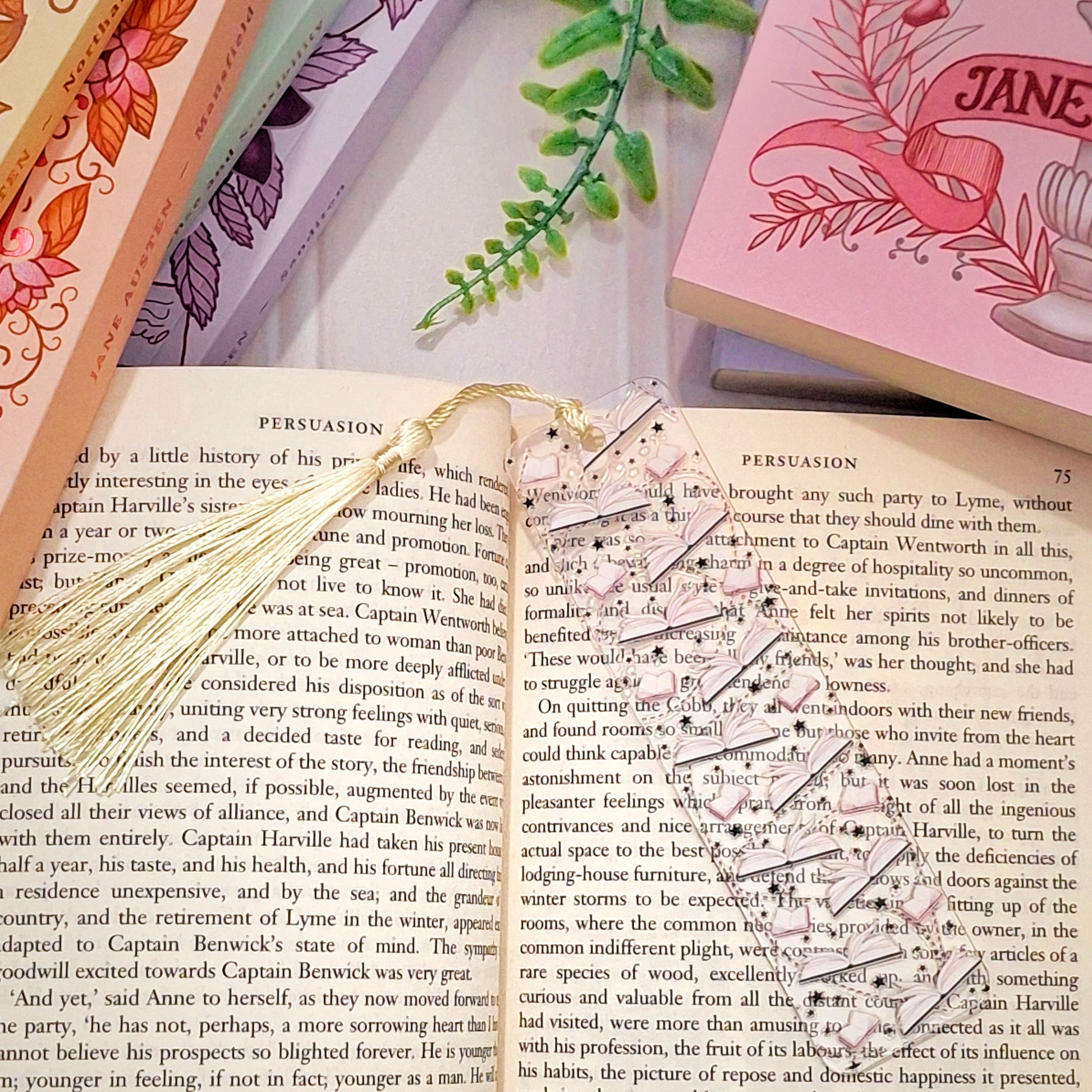Book themed bookmark with tassel for book lovers, lying across an open book page.