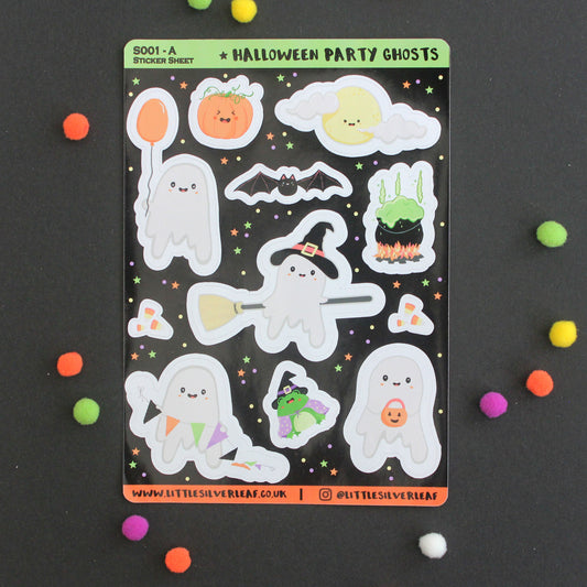 A sheet of cute Halloween party ghost stickers on a black background, surrounded by colorful pom-poms. The stickers feature various smiling ghosts, pumpkins, a bat, and candy corn.