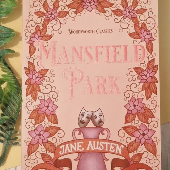 Short video showing a Paperback Pages acrylic bookmark with tassel being removed from its packaging, held up close to the camera to highlight the intricate open book illustrations design, then placed between the pages of a book to demonstrate how it works as a decorative reading bookmark.